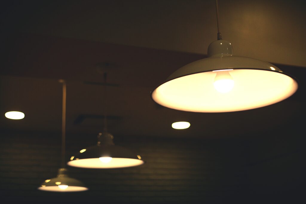 close up illuminated electric lamps hanging ceiling
