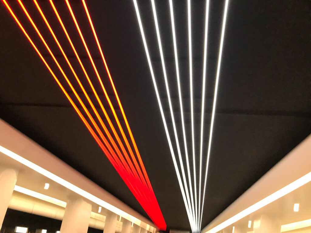 Abstract contemporary architecture background, ceiling lighting corner, neon light stripe over red white